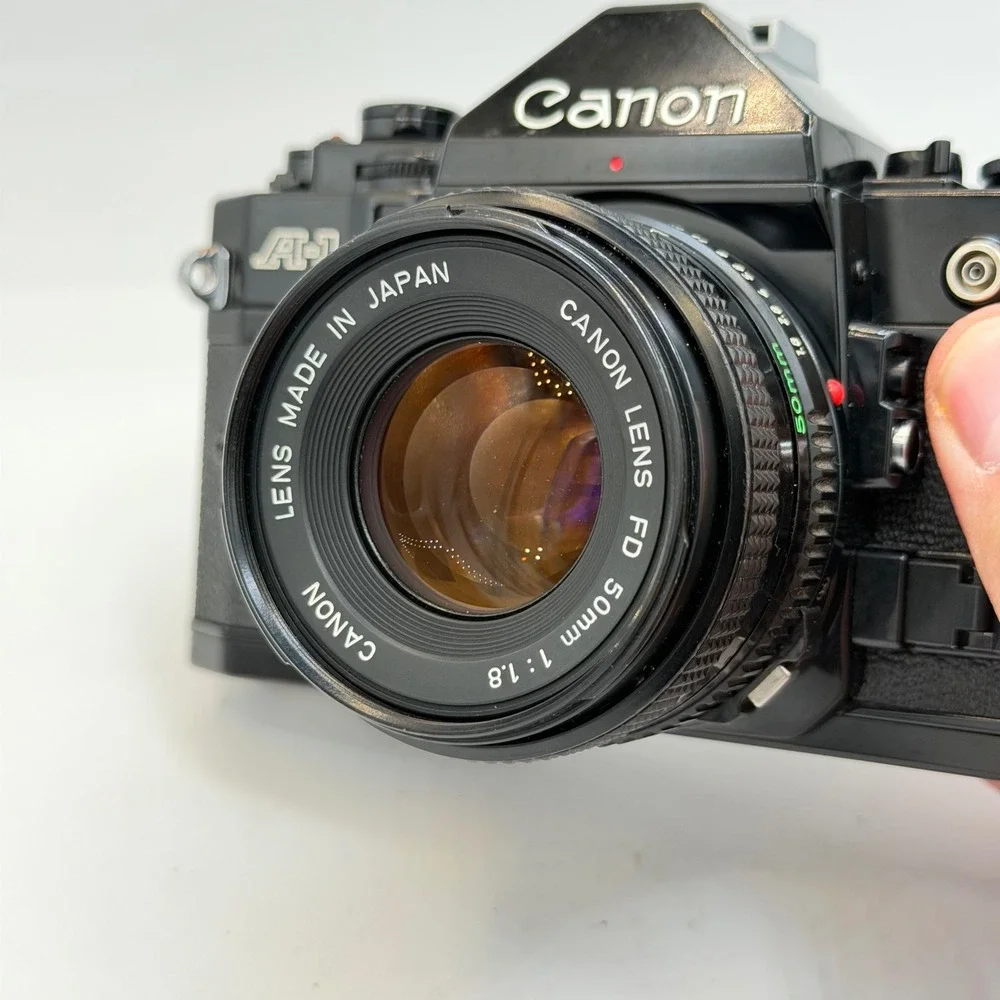 Canon A-1 35mm Film SLR Camera with FD 50mm 1:1.8 Lens, Filter, Cap Black TESTED